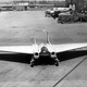 The intakes on the wingtips of the XP-79B supplied air to bellows that powered split-aileron controls. A Fairchild AT-21 Gunner is parked in the background. (US Air Force)